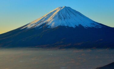 Scenic view of Mount Fuji with surrounding lakes and forests, showcasing Japan’s iconic landscape