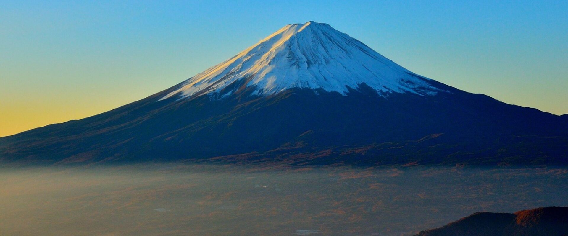 Scenic view of Mount Fuji with surrounding lakes and forests, showcasing Japan’s iconic landscape